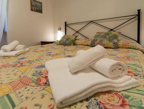 a bed with towels and pillows on it at Villa Magnolia in Bolsena