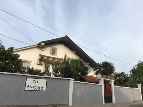 a house with a sign in front of it at TIKI Apartments in Gevgelija