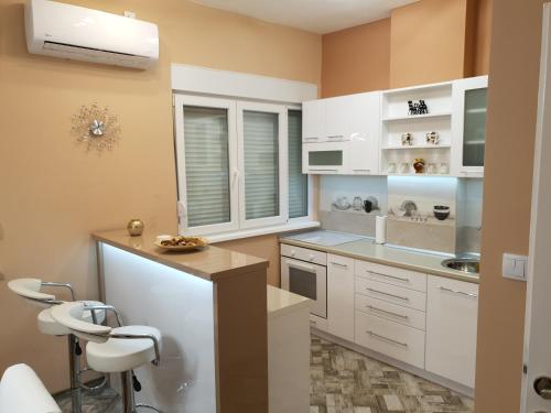 a kitchen with white cabinets and a counter at Apartment Centar Exclusive Smederevo in Smederevo