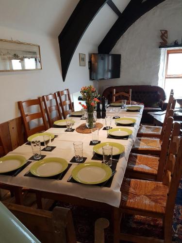 a long table with plates and glasses on it at James John Hamilton House and backpacker hostel in Fishguard
