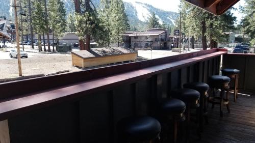 a bar with stools and a view of a mountain at Gondola Lodge & Tahoe Beach Club in South Lake Tahoe