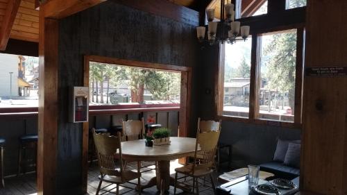 a dining room with a table and chairs and windows at Gondola Lodge & Tahoe Beach Club in South Lake Tahoe