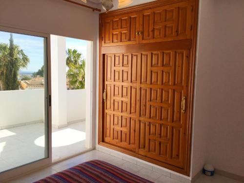 a wooden door in a room with a balcony at Apartment Quesada in Ciudad Quesada