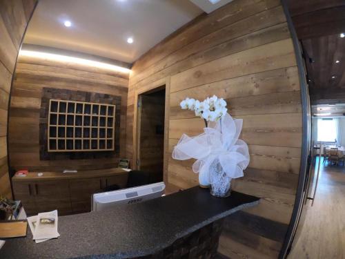a kitchen with a counter with flowers in a vase at Hotel Ristorante Miramonti in Val Masino
