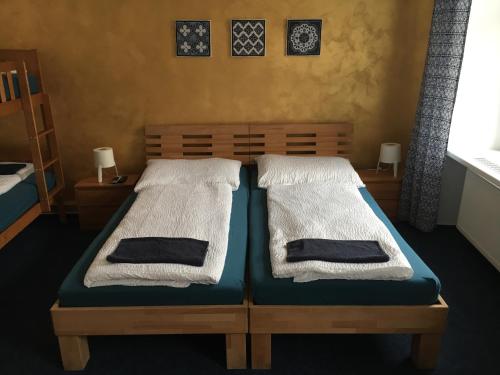 a bedroom with two beds with towels on them at Mikulov Inn - hotel Zeme in Mikulov