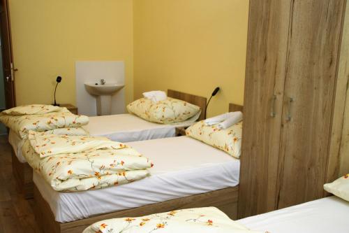 a group of three beds in a room at Penzion Daníž in Chvalovice