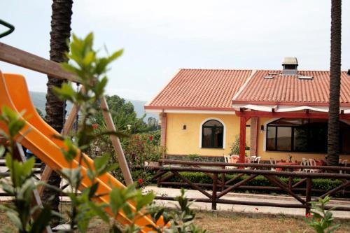 a small yellow house with a red roof at Cascina Concetta in Pizzo