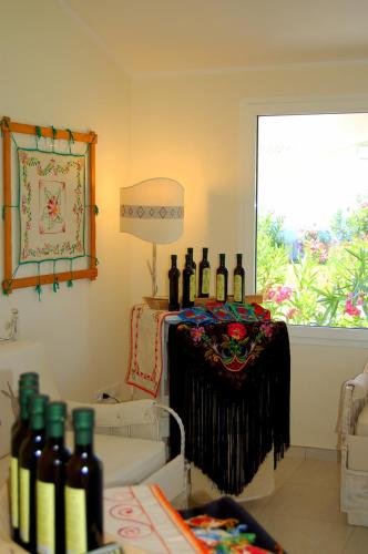 a room with a bunch of wine bottles on a table at Hotel Budoni Beach in Budoni