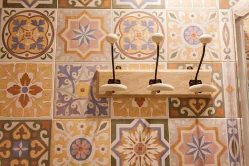 a bathroom with colorful tiles on the wall at Graffiti Suites Málaga in Málaga