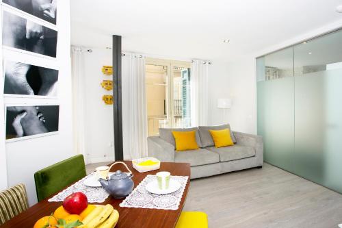 a living room with a table and a couch at Graffiti Suites Málaga in Málaga