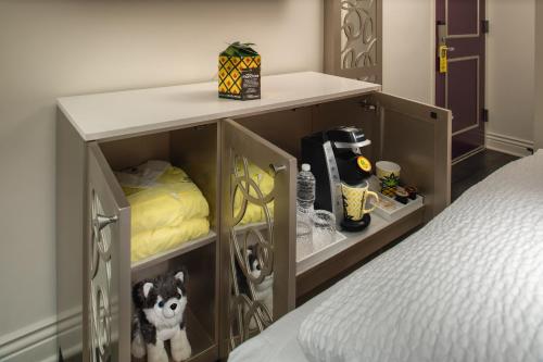 a room with a bed and a cabinet withartments at Staypineapple, An Artful Hotel, Midtown New York in New York