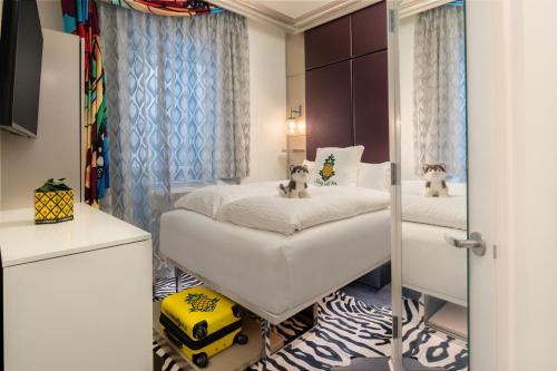 a bedroom with two beds and a mirror at Staypineapple, An Artful Hotel, Midtown New York in New York