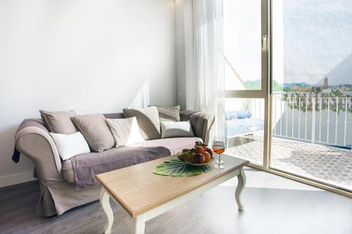 a living room with a couch and a table at Graffiti Suites Málaga in Málaga