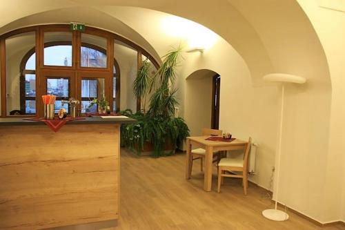 a dining room with a table and a counter at Penzion Daníž in Chvalovice
