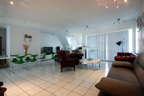 a living room with a couch and a table and chairs at P13 by Stay in Iceland in Reykjavík
