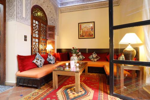 a living room with a couch and a table at Riad Daria Suites & Spa in Marrakech