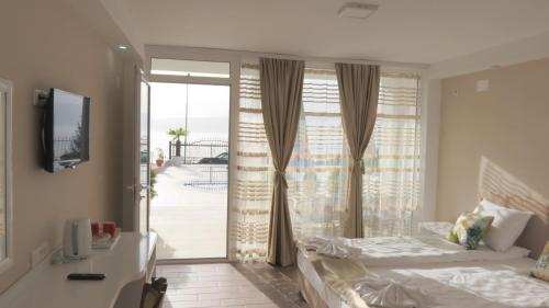 a bedroom with a bed and a sliding glass door at Villa Angelos in Ohrid