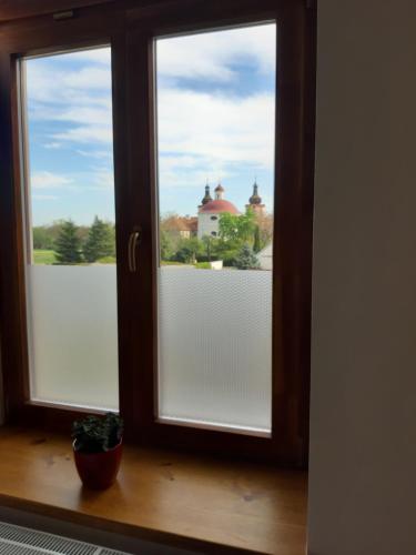 a window with a view of a building at Penzion a restaurace U Hájků in Nové Dvory