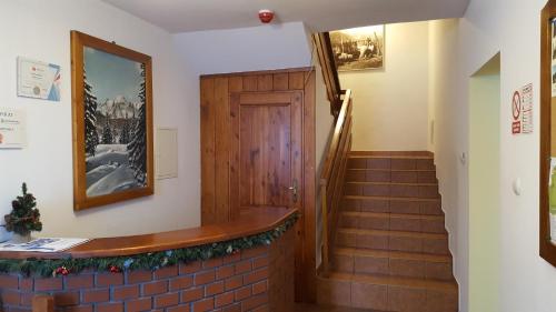 a hallway with a staircase and a door with a christmas decoration at NIEZAPOMINAJKA in Szczyrk