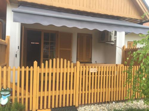 a wooden fence in front of a house at Apartma Jelenček in Moravske Toplice