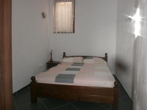 a bedroom with a bed in a room at APARTMANI LAŠTRO in Jesenice