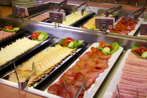 a counter topped with lots of different types of food at Ibis Budapest City in Budapest