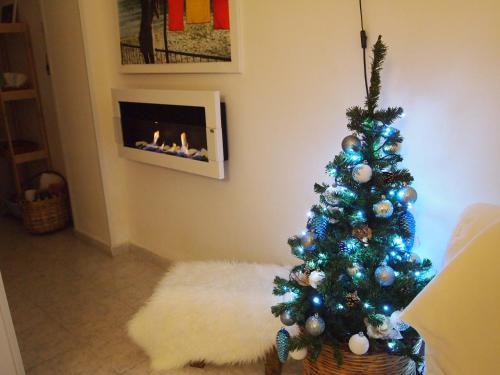a christmas tree in a living room with a fireplace at Terre del Faro in Scanzano