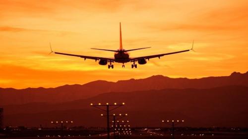 an airplane is taking off from a runway at sunset at Vacanza Complex in Benidorm