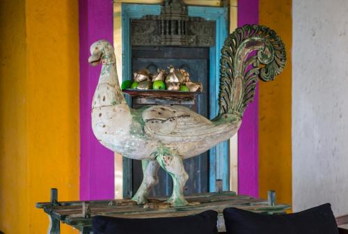 a statue of a chicken sitting on a table at Tangerine Beach Hotel in Kalutara