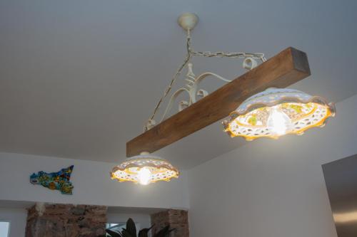 a chandelier and two lights hanging from a ceiling at La Zagara in Aci Castello