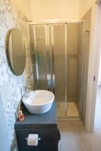 a bathroom with a sink and a shower at La Zagara in Aci Castello