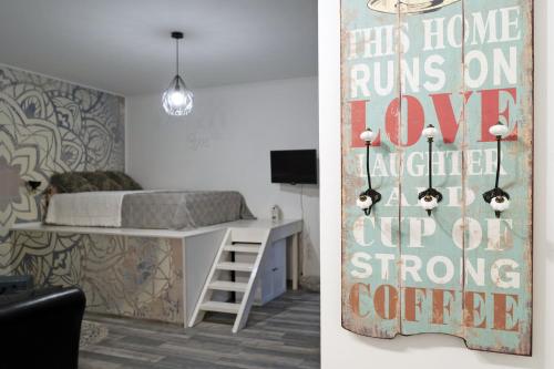 a bedroom with a bed and a desk with a sign at Standard Apartment by Hi5 -Akácfa 57 in Budapest