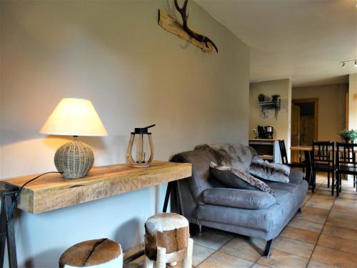 a living room with a couch and a table at Relais des Eveux in La Roche-en-Ardenne