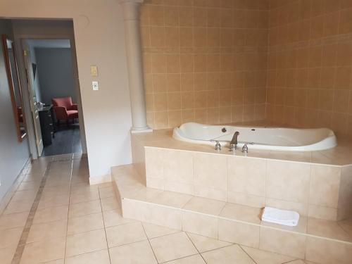a bathroom with a bath tub in a room at 7 Nights Stay in Niagara Falls