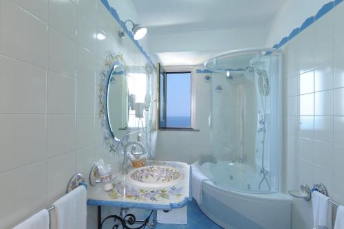 a bathroom with a sink and a tub and a shower at Hotel Villa Maria Pia in Praiano