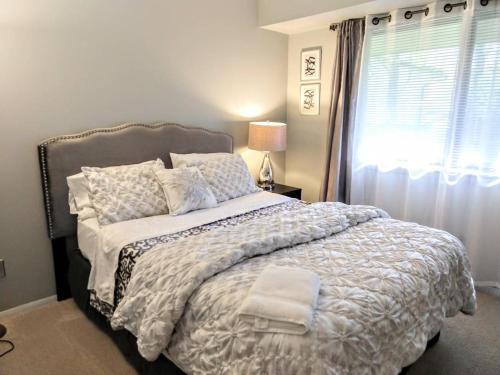 a bedroom with a large bed and a window at Inviting Condo in Central Raleigh in Raleigh