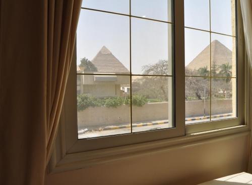 a window with a view of the pyramids at Pyramids Sun Capital in Cairo