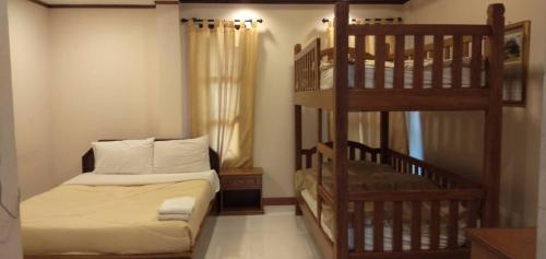a bedroom with a bunk bed and a ladder at Kraisaeng Place in Phitsanulok