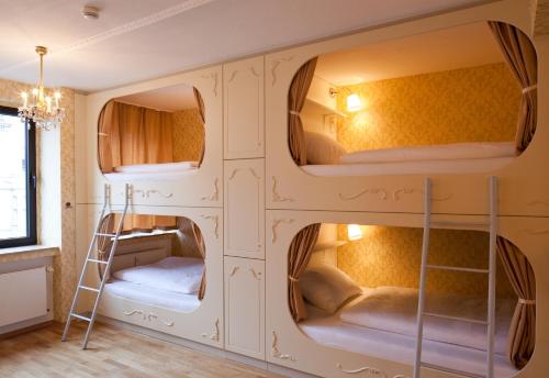 a room with four bunk beds with a ladder at Hostel die Wohngemeinschaft in Cologne