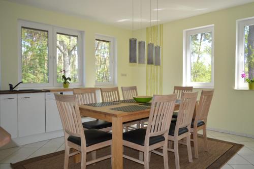 a kitchen with a wooden table and chairs at Ferienhaus Sonne in Cottbus