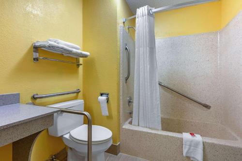 a small bathroom with a toilet and a shower at Econo Lodge in Nashville