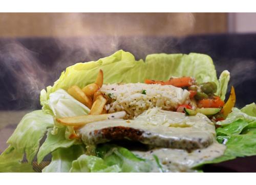 a lettuce sandwich with meat and vegetables and french fries at Udaan Olive Hotel & Spa, Pelling in Pelling