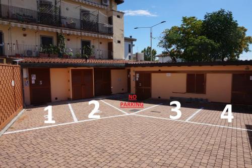 a parking lot with a no parking sign in front of a building at Bergamum F.L. in Bergamo