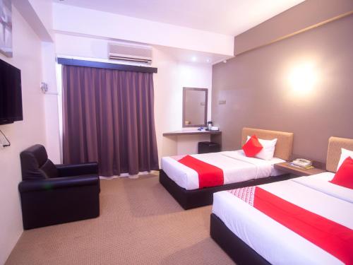 Tempat tidur dalam kamar di Super OYO 979 Hua Kuok Inn