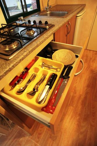a drawer in a kitchen with utensils on it at Camping Bella Sardinia in S'archittu Cuglieri