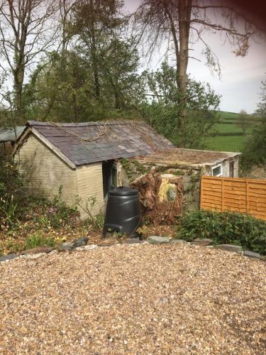 a house with a trash can in the yard at Heddfan in Carmarthen