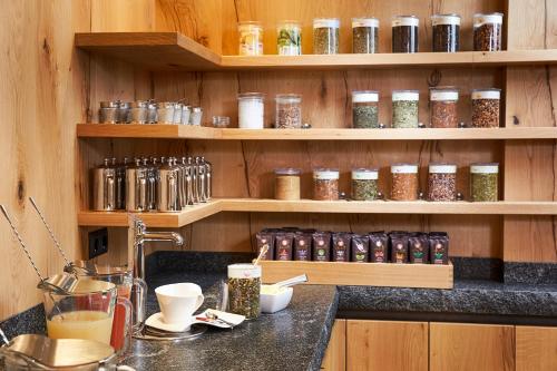 a kitchen with shelves filled with jars of spices at Hotel Tirol in Ischgl