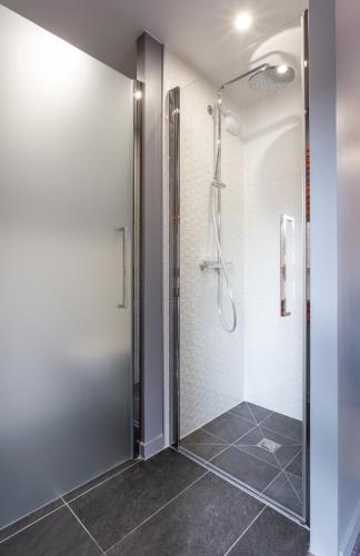 a shower with a glass door in a bathroom at Hotel Base Camp Lodge - Bourg Saint Maurice in Bourg-Saint-Maurice