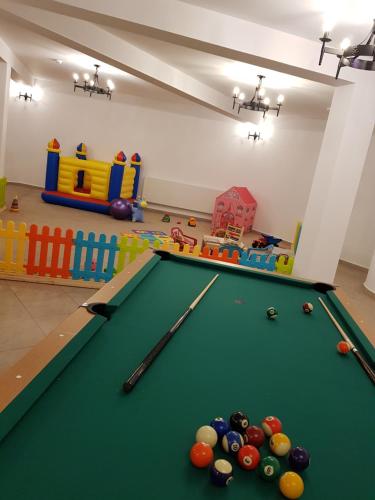 a room with a pool table and play equipment at Complex Turistic Comoara Bucovinei in Corlata