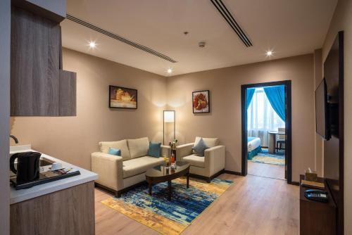 a living room with a couch and a table at Naviti Warwick Dammam in Dammam